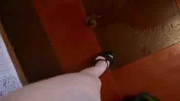 Masked female defecating and urinating on the ground